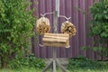 Small piles of firewood from brown logs hang on a wooden pole Royalty Free Stock Photo