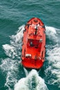 Small pilot boat sailing with waves