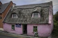 Small pink cottage with thatched roof Royalty Free Stock Photo