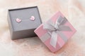 Small pink and gray jewelry gift box with bow on lace background Royalty Free Stock Photo