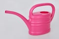 Small pink plastic watering can isolated Royalty Free Stock Photo