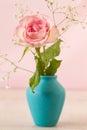 Small pink rose on blue vase Royalty Free Stock Photo