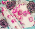 Small pink roses frozen in ice. Natural ice background with flowers of roses. Selective focus.