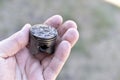 A small piston in the hand from an internal combustion engine