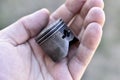 A small piston in the hand from an internal combustion engine