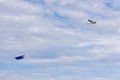 Small plane with blank advertising sign flying over a sky with clouds