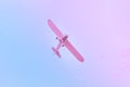 Small plane flying against the blue, purple, pink sky Royalty Free Stock Photo