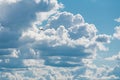 A small plane in front of giant clouds after the storm. The clouds break open and blue sky appears