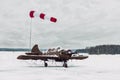 A small plane stands in a case protecting it from precipitation at the airport at the airport in the winter