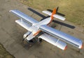 A small plane stands in the parking lot of an old airfield. Wings. Airport. Flights by plane