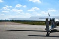 A small plane stands in the parking lot of an old airfield. Wings. Airport. Airfield. Flights by plane