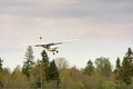 Small plane stands on the runway against the background of the forest Royalty Free Stock Photo