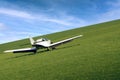 A small plane takes off from a grassy airport Royalty Free Stock Photo