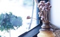 A small plant pot displayed in the window. Bouquet of flowers near window Royalty Free Stock Photo