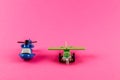 Small plastic airplane and helicopter with copy space on pink background Royalty Free Stock Photo