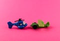 Small plastic airplane and helicopter with copy space on pink background Royalty Free Stock Photo