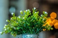 Small plastic flowers in a pot with pentagon bokeh