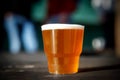 Small plastic glass with light beer. Royalty Free Stock Photo