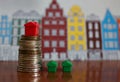Small plastic house model on top of stacked coins Royalty Free Stock Photo