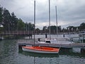 Small plastic sailboat mooring in marina