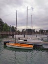 Small plastic sailboat mooring in marina