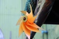 Small plastic wind turbine toy in orange color Royalty Free Stock Photo