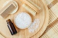 Small plate with white epsom bath salts (foot soak)  bottle of essential oil  wooden hair brush  massage body brush. Royalty Free Stock Photo