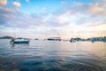 Small and pleasure boats in harbor with Hellenic Seaways ferry leaving the island