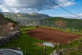 A small plowed field on a farm. Beautiful old mountain village