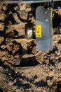 Small plowing machine in hands of a farmer making arable in black soil