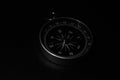 Small pocket compass on black background