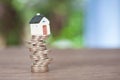 Small pocket house model placed on a stack of euro coins Royalty Free Stock Photo