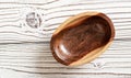 Small polished rosewood bowl on white boards desk, closeup view from above