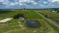 Small Pond With A Water Fountain Is Situated Near A Curved Pathway And A Quaint House Royalty Free Stock Photo