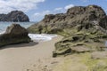 Small pools and volcanic rocks on goldenrod sand at Calheta, Porto Santo island Royalty Free Stock Photo