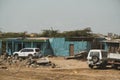 A small and poor slum house and cars in Djibouti. Editorial shot in Djibouti