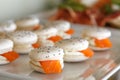 Small red fish sandwiches on a tray