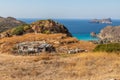 Small porr house with Plathiena beach in background