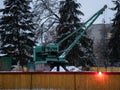 Small portable crane at plumbing pipelaying construction site