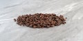 Small portion of cocoa nibs on a gray countertop