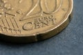 A small portion of a twenty-cent metal coin in close-up on the table. Metal money of Europe.