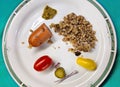 Small portions of sausage, buckwheat porridge, pickles, yellow and red Cherry tomatoes, Pesto sauce. A bit of everything yummy