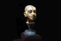 Small portrait sculpture of young pharaoh Tutenkhamun in a museum. Close up view.