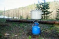 A small pot on the gas stove.