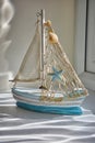 Small pottery boat in distorted sunlight through window. Royalty Free Stock Photo