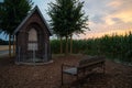 small prayer house in between corn fields with trees and a bank at sunset Royalty Free Stock Photo