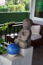 Small praying buddha statue in front of garden patio Royalty Free Stock Photo