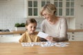 Small preschool kid girl learning math with grandmother.