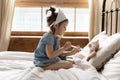 Small preschool kid girl making prick injection to fluffy toy.