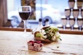 Small present box with bow and bouquet of flowers on wooden tabl